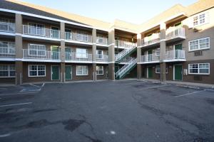 an empty parking lot in front of a building at HomeTowne Studios by Red Roof Denver - Lakewood West in Lakewood