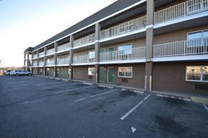 an empty parking lot in front of a building at HomeTowne Studios by Red Roof Denver - Lakewood West in Lakewood