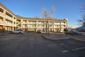 an empty parking lot in front of a building at HomeTowne Studios by Red Roof Denver - Lakewood West in Lakewood