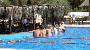 un gruppo di persone in piscina di Surfing Beach Huts a Santa Maria