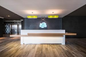 a reception desk in a room with a wall at Holiday Inn Southampton, an IHG Hotel in Southampton