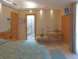 a bedroom with a bed and a sink and a tub at Hotel Sempione in Milan