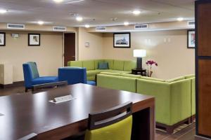 a waiting room with a table and chairs at Comfort Inn in Oxon Hill