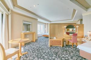 a hotel room with a desk and a mirror at Hotel Seagull Tenpozan Osaka in Osaka