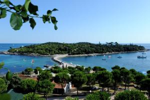 uma vista para uma praia com barcos na água em Maistra Select All Suite Island Hotel Istra em Rovinj