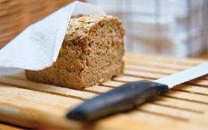 a knife sitting next to a loaf of bread at Radfahrerherberge Krems in Krems an der Donau