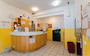 a restaurant with a counter in a room with yellow walls at Radfahrerherberge Krems in Krems an der Donau