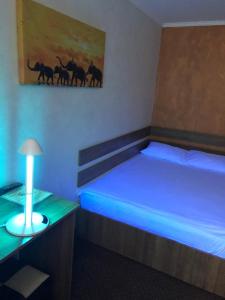 a room with two beds with blue lights on it at Pensiunea El Passo Targu Mures in Târgu-Mureş