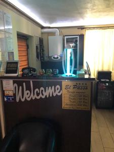 a counter with a welcome sign at a store at Pensiunea El Passo Targu Mures in Târgu-Mureş