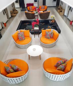 a group of chairs with colorful pillows in a lobby at Gading Guest House in Mataram