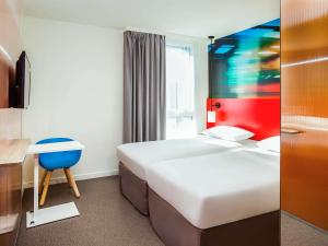 מיטה או מיטות בחדר ב-Ibis Styles Mulhouse Centre Gare