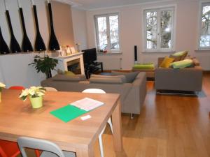 a living room with couches and a table and a living room at Apartment Het Blekershuys in Bruges