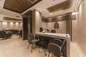 a salon with chairs and a bar in a room at World Heritage Center Hotel in Istanbul