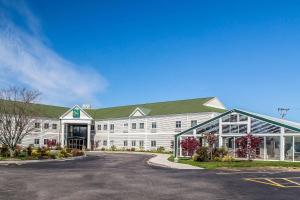 ein großes weißes Gebäude mit grünem Dach in der Unterkunft Quality Inn & Suites Middletown - Newport in Middletown