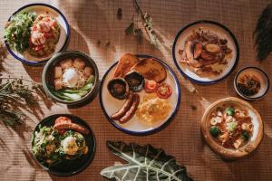 a table with plates of food on a table at Kimpton Da An Taipei- an IHG Hotel in Taipei