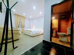 a room with a bedroom with a bed and a mirror at CityCenterHotel Shkoder in Shkodër