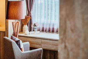 a room with two chairs and a window at So Boutique Jomtien Beach Pattaya in Jomtien Beach