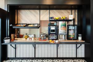 a counter with a refrigerator and some food on it at B&B HOTEL Thionville Centre Gare Porte du Luxembourg A31 in Thionville