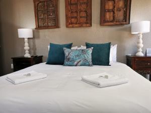 A bed or beds in a room at Excellent Guest House