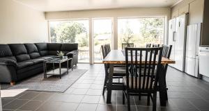 a kitchen and living room with a table and chairs at Saxnäs Ferieboende L. Erik in Färjestaden