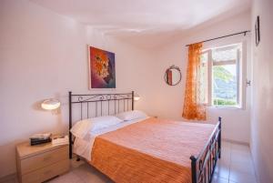 a bedroom with a bed and a window at Residence La Valdana in Capoliveri