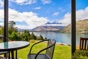 a view of a lake from a table and chairs at Holiday Inn Queenstown Frankton Road, an IHG Hotel in Queenstown