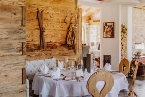 a dining room with a table with white table cloth at Hotel Berghof - St Johann in Salzburg in Sankt Johann im Pongau