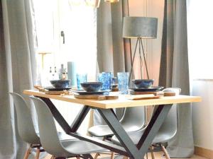 a wooden table with chairs and a lamp on it at Villa Waulsort in Waulsort