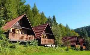 een rij cottages op een heuvel met bomen bij Hotel Sepetná - Silvestr s polopenzí, animačním programem a silvestrovskou párty! in Ostravice