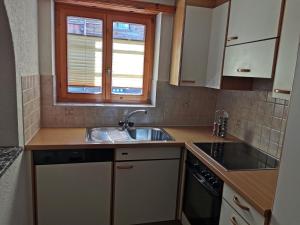 a small kitchen with a sink and a window at Imseng in Wiler