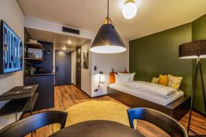 A bed or beds in a room at Black F House - Serviced Apartments