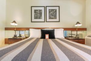 a bedroom with a large bed with two lamps at Little Beaver Inn in Green Mountain Falls