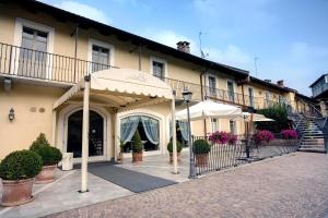 un bâtiment avec des parapluies devant lui dans l'établissement Hotel Cascina Di Corte, à Venaria Reale