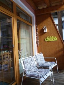 a pair of chairs sitting on a porch at Appartement Gurgl in Obergurgl