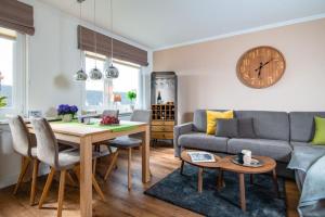 a living room with a couch and a table at Appartement-Leuchtturmblick in Hörnum