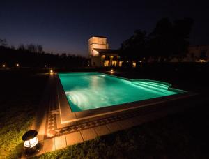 a swimming pool in front of a house at night at Residence Cà Beregana in Vicenza