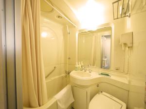 a bathroom with a toilet and a sink and a shower at Hotel Route-Inn Ichinoseki Inter in Ichinoseki