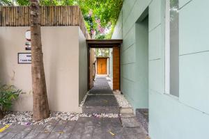 a hallway of a building with a orange door at Villa Athena in Seminyak