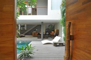 an open door to a house with a pool at Villa Athena in Seminyak