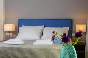 A bed or beds in a room at Elounda Colour Apartments