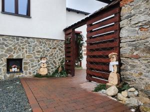 two stuffed animals sitting on the side of a building at Apartmány Vízmberk in Velké Losiny