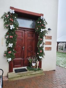 a wooden door with christmas wreaths on it at Apartmány Vízmberk in Velké Losiny