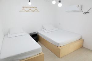 Vuode tai vuoteita majoituspaikassa Minihotel Poongdaengi