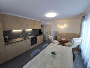 a kitchen and living room with a table and chairs at Chalet Monte-Pente in Megève