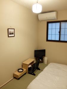 A bed or beds in a room at Guesthouse Engawa