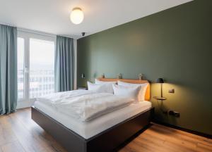 A bed or beds in a room at Black F House - Serviced Apartments