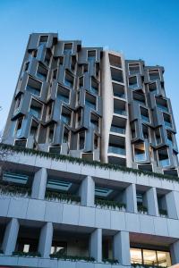 a tall building with balconies on top of it at Crowne Plaza Sydney Burwood by IHG in Sydney