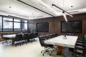 a conference room with tables and chairs and a flat screen tv at Crowne Plaza Sydney Burwood by IHG in Sydney