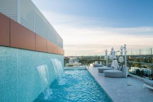 a swimming pool on the roof of a building at Crowne Plaza Sydney Burwood by IHG in Sydney