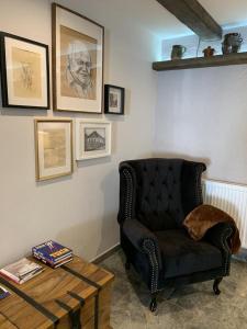 a living room with a chair and a coffee table at Ubytovanie pod Skalkou in Dolný Kubín